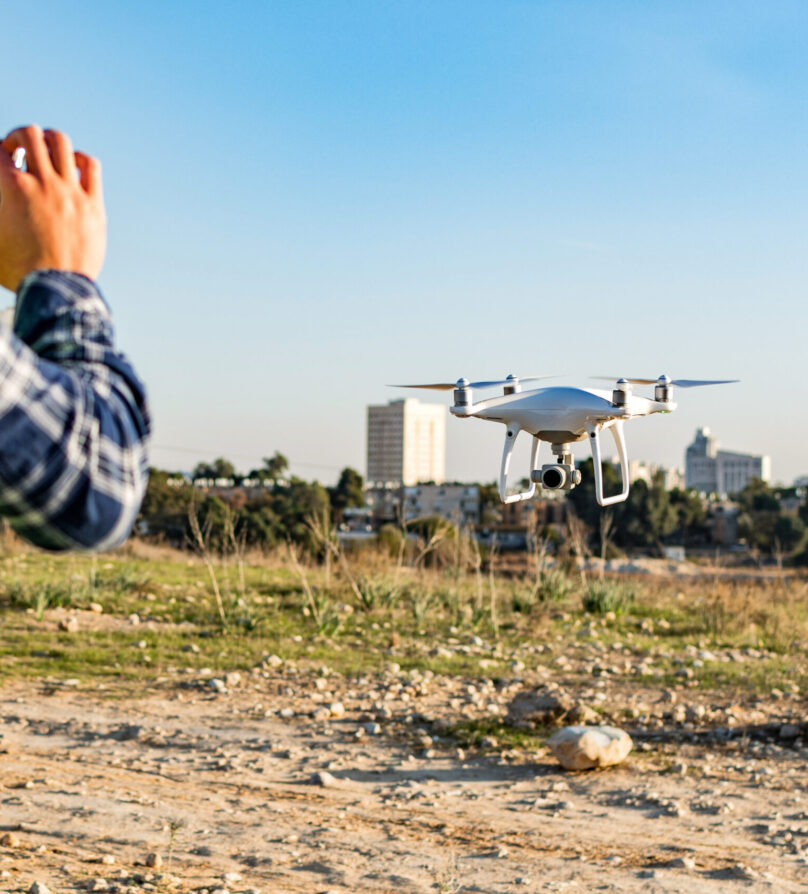 Construction worker operating a drone on a construction site A construction worker operating a drone on a construction site